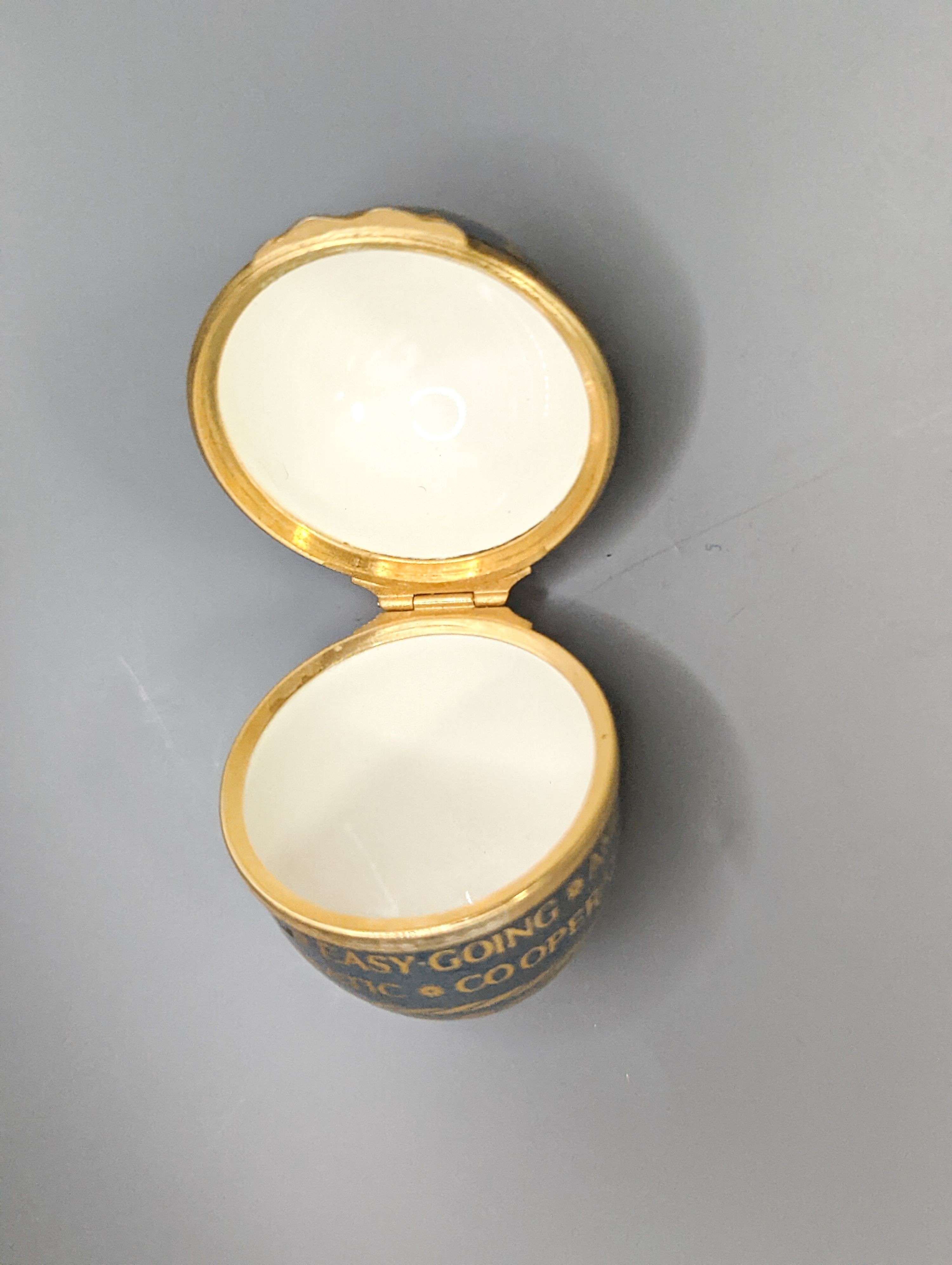 Two silver gilt mounted enamelled eggs with interior seascapes, on silver gilt stands, Birmingham, 1985 & 7 and a smaller similar gilt metal mounted zodiac egg, tallest 8.5cm